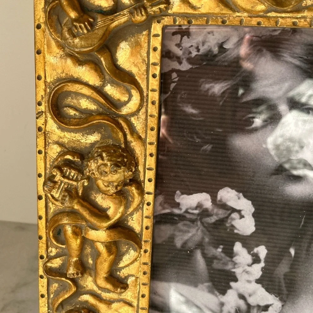 Large gilded Cherub Picture Frame holds 5”x7”. Rare